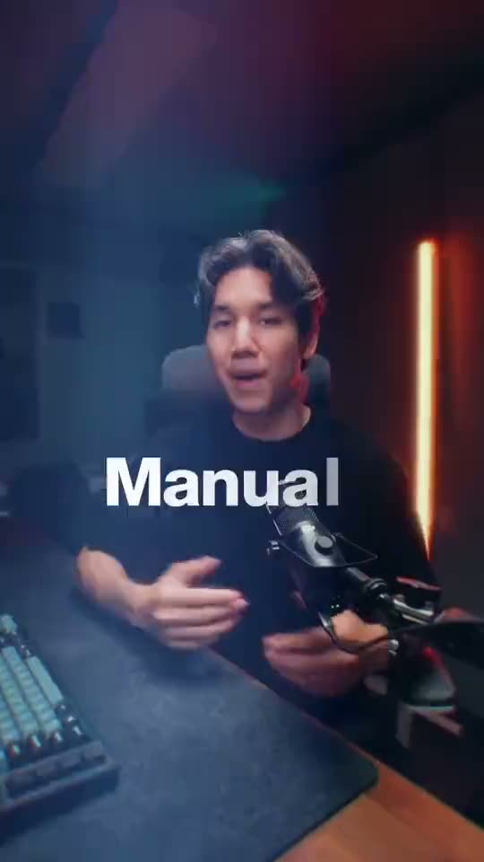 A vertical video frame with the word "Manual" in clean white bold sans-serif, rendered so the subject's shoulder passes in front of the text